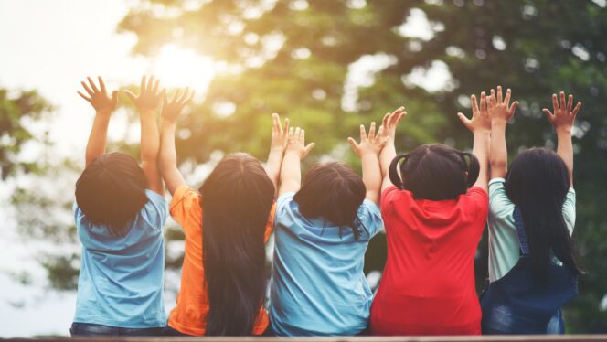 
Group of kids friends arm around sitting together